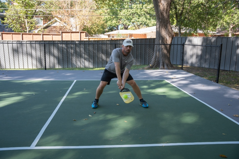 The pickleball transition zone  (aka “No Man’s Land”) is the awkward area between the baseline and the kitchen on every pickleball court.